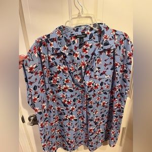 Short cap sleeve blue blouse with red flowers.